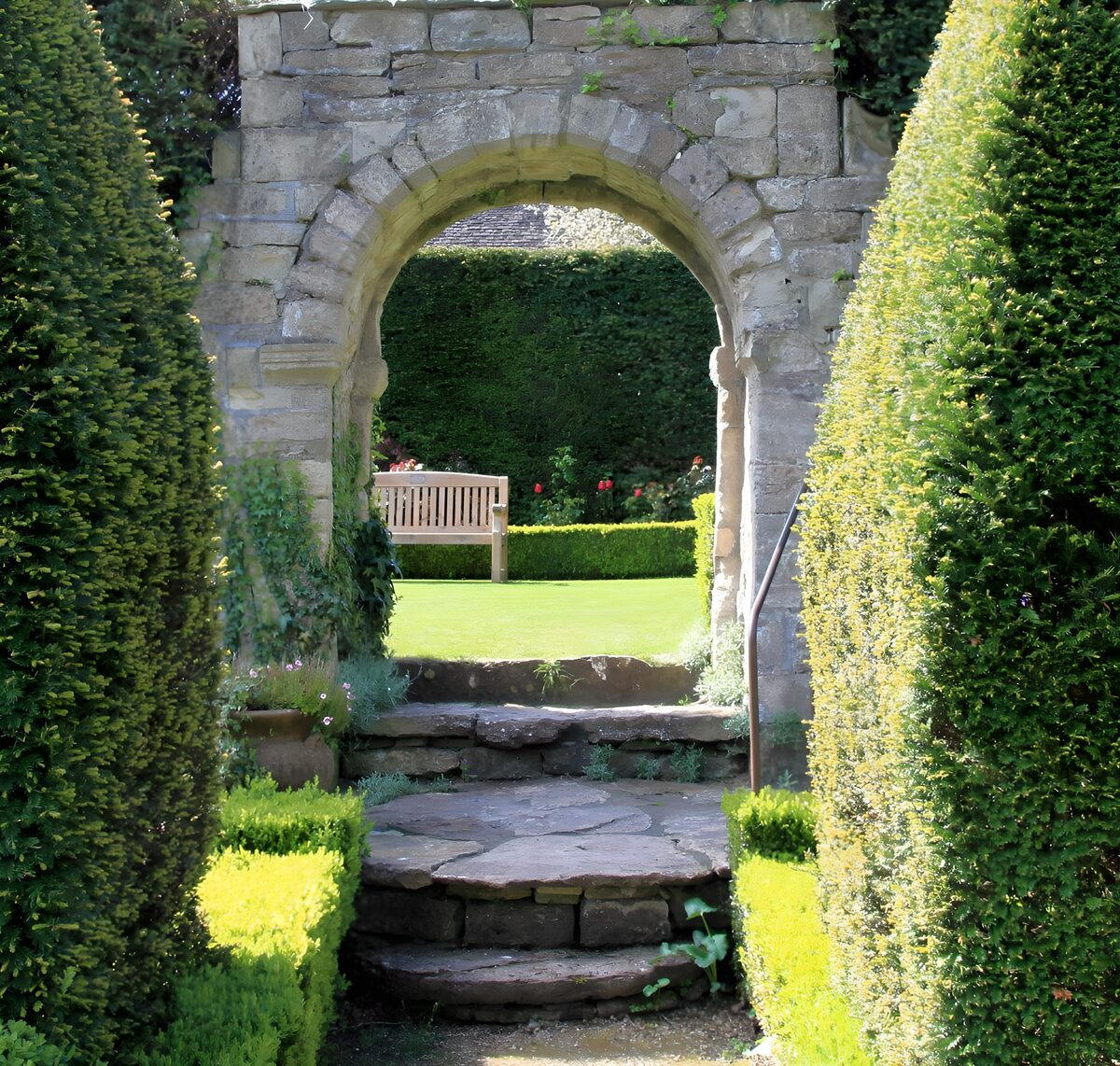 A stone arch holds a pocket of sunshine