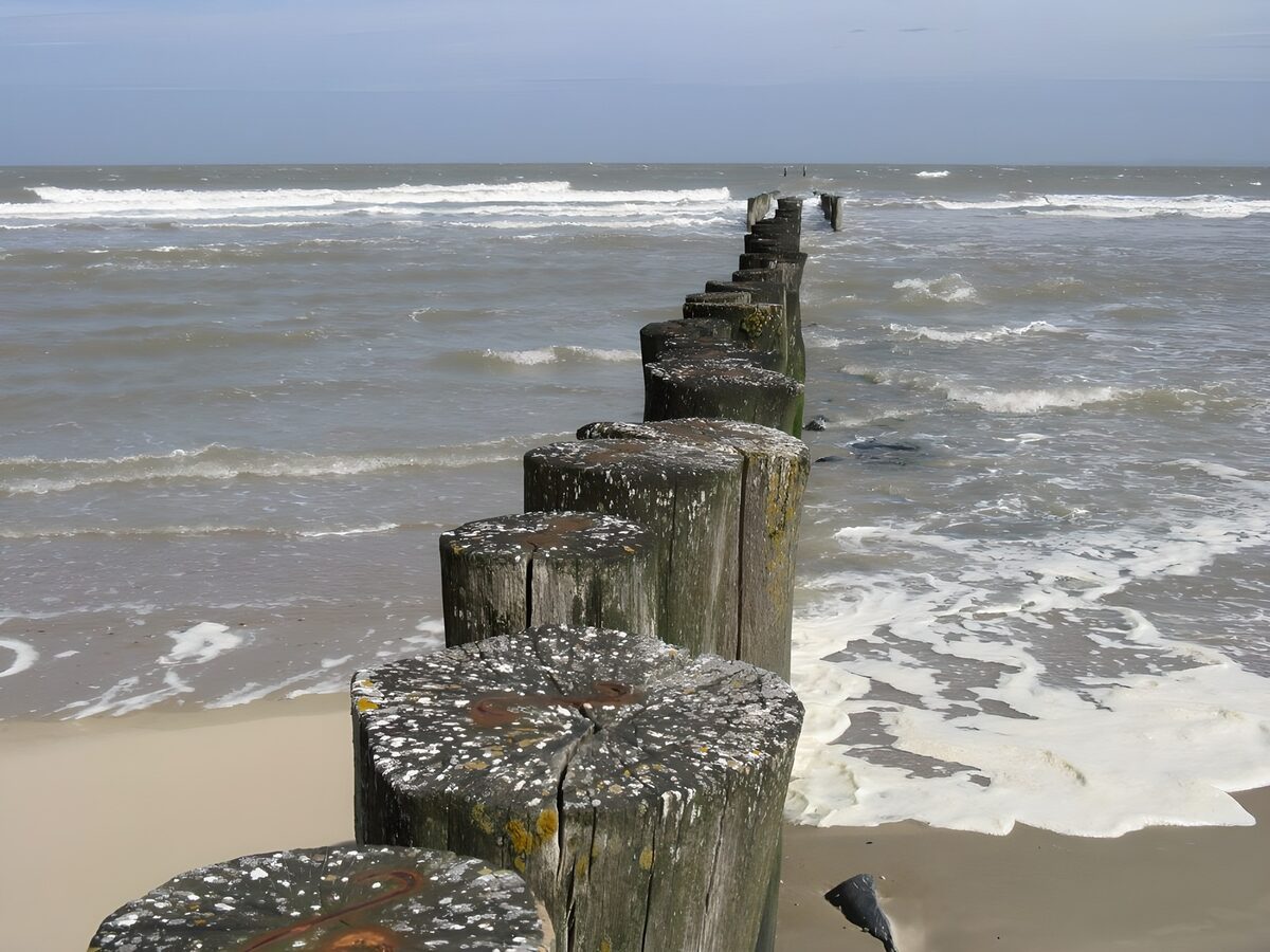 Weathered groyne in choppy seas