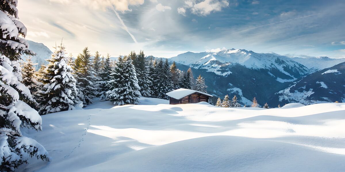 Wooden cabin in deep mountain snow