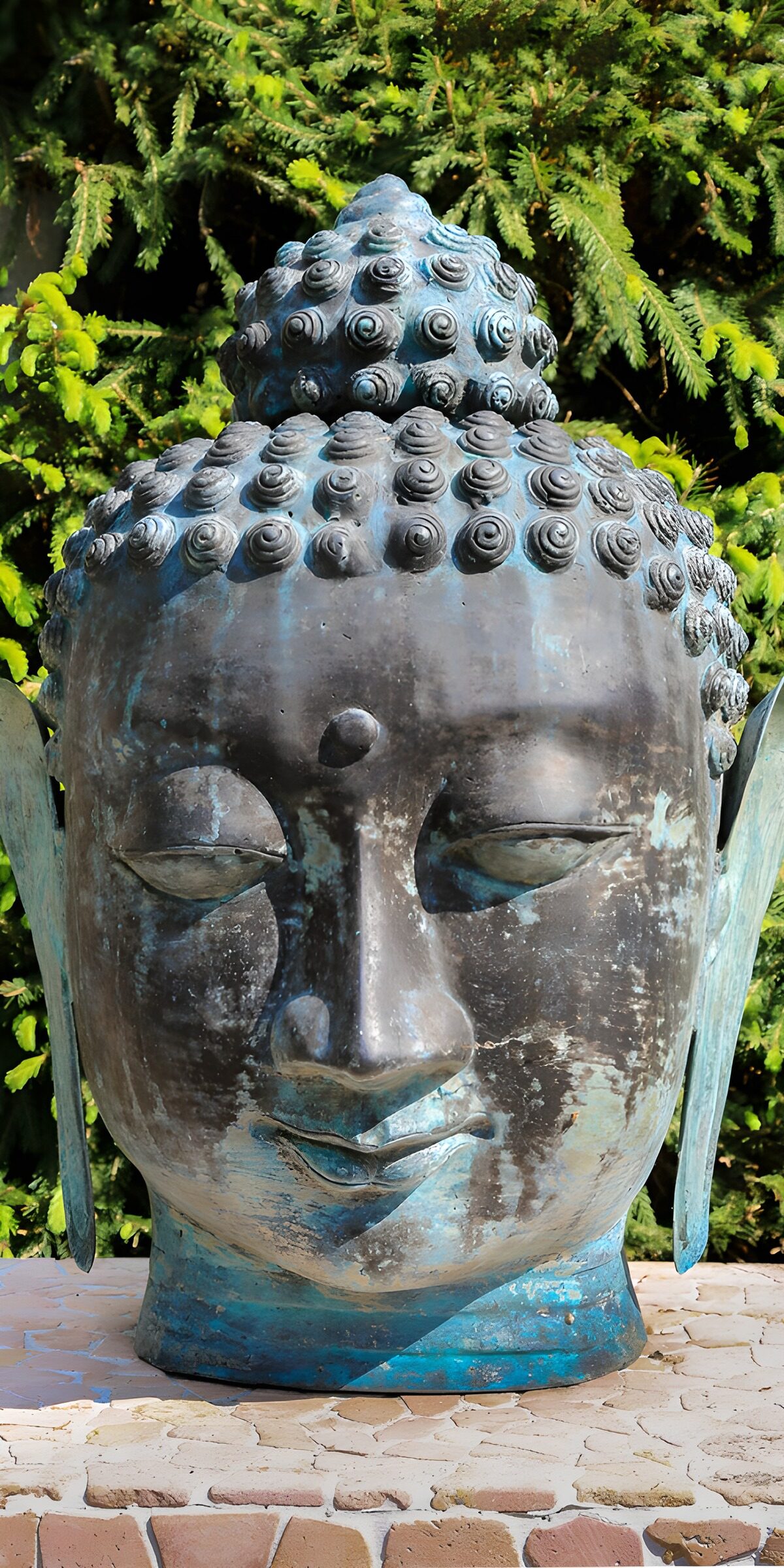 Weathered Buddha head in the sunshine