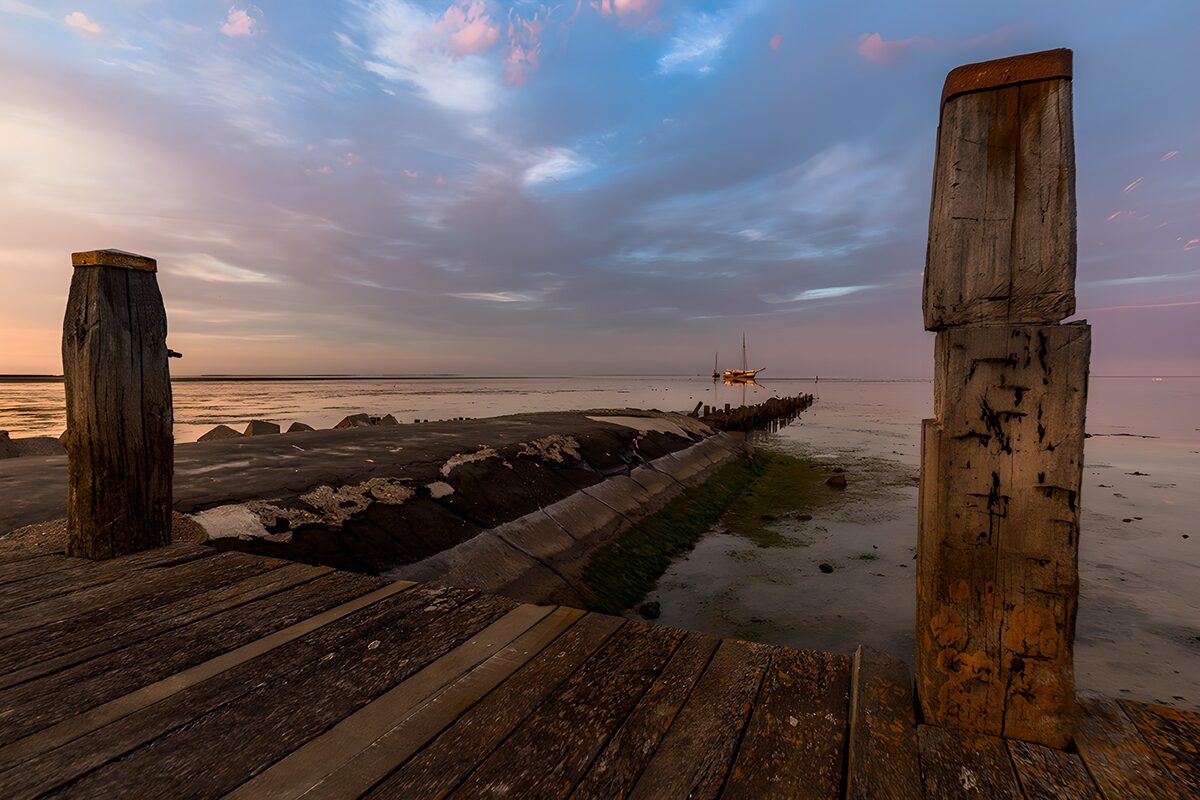 Weathered wooden jetty at sunset