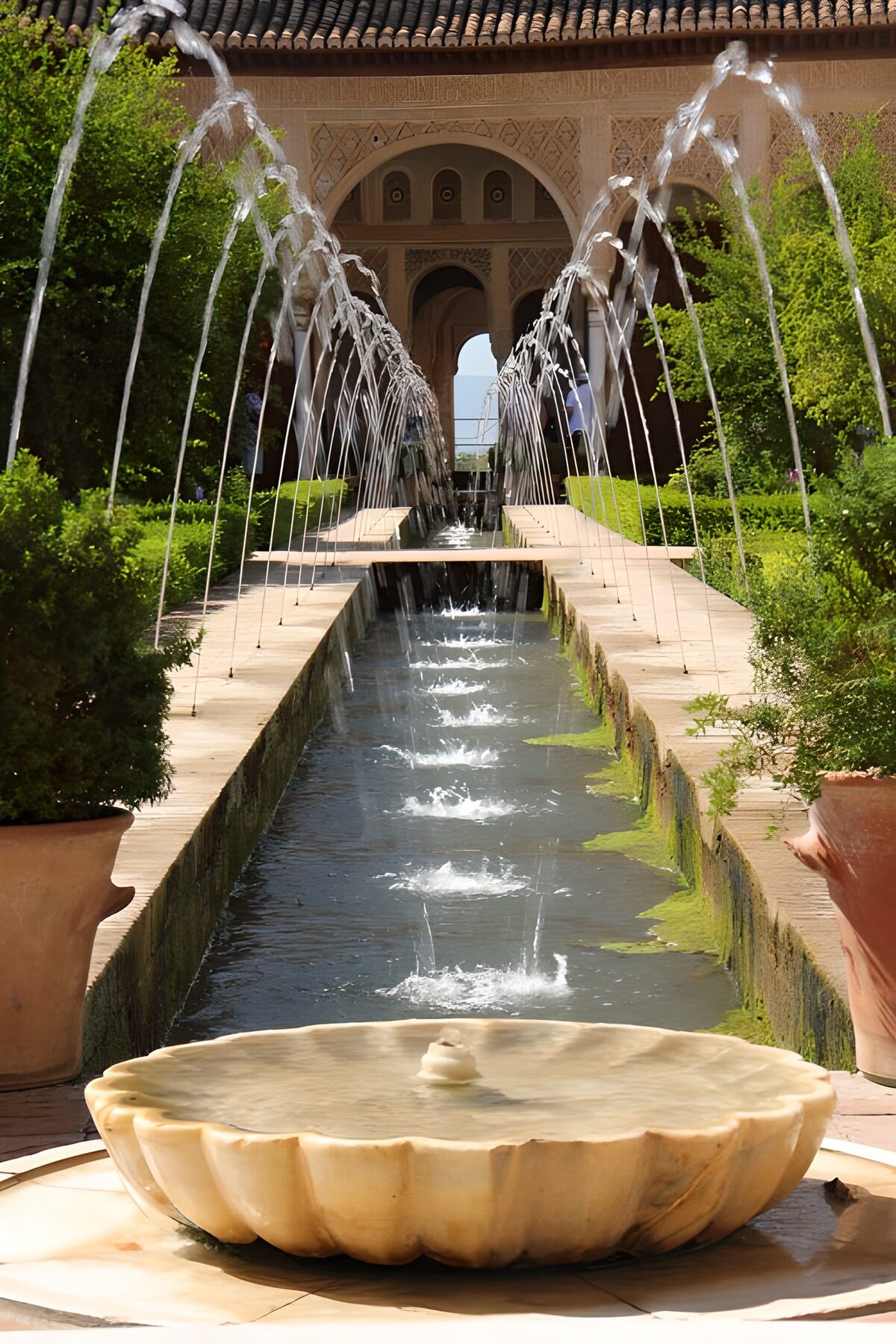 Sunlit courtyard with arching fountains