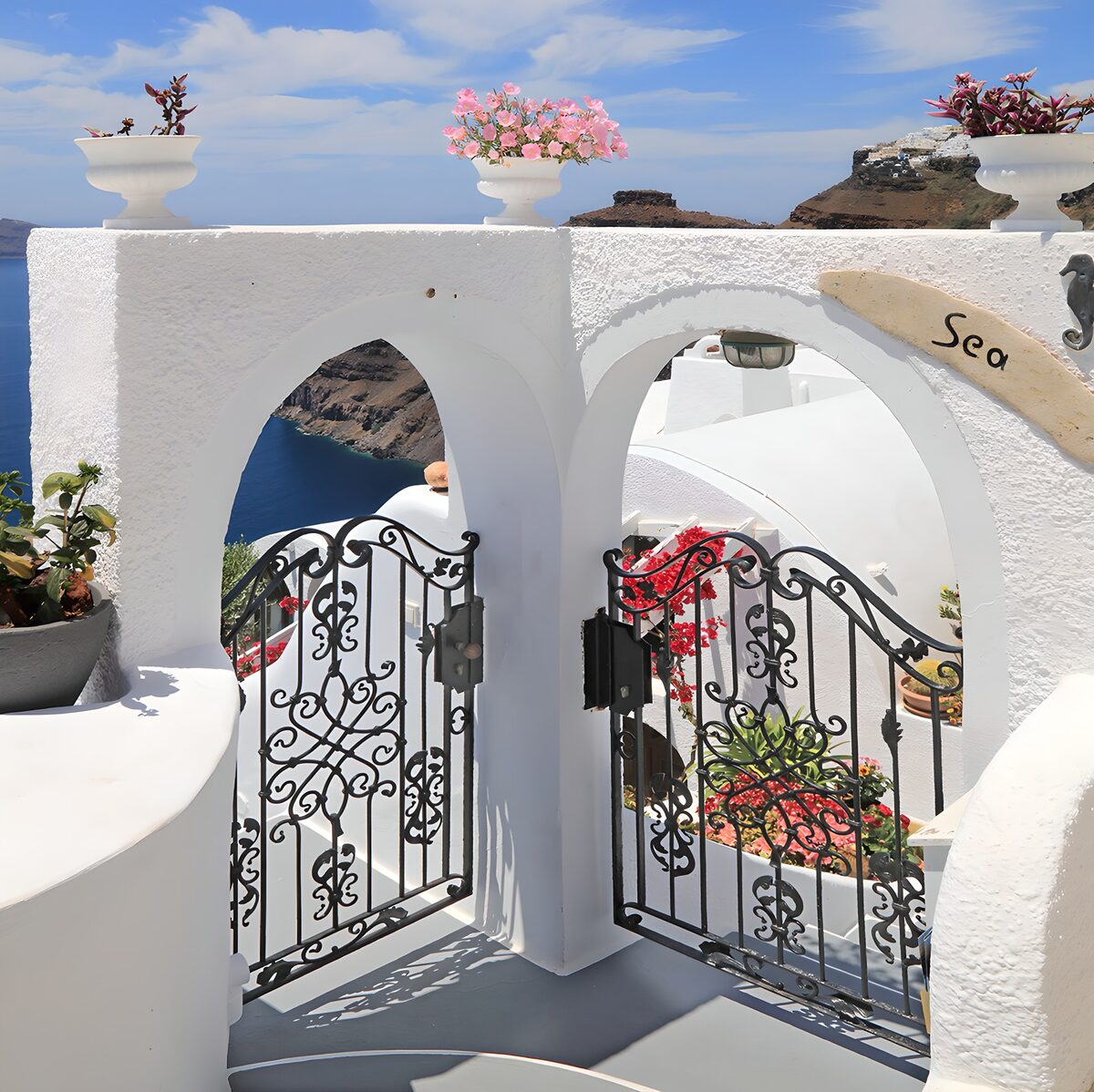 White arches on a sunlit coastal terrace