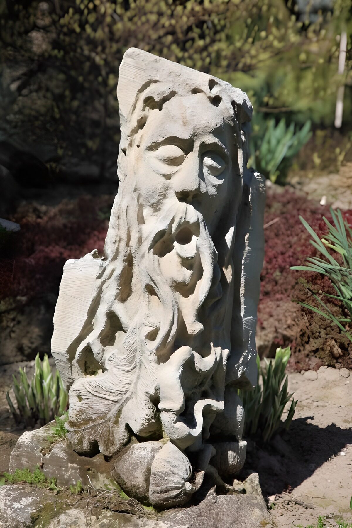 Bearded stone face in sun and shadow