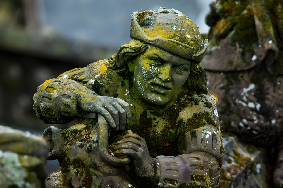Weathered stone figure holding a jug