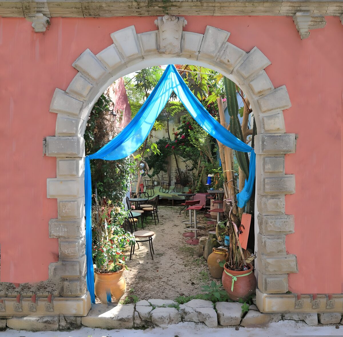 Pink arch into a leafy courtyard
