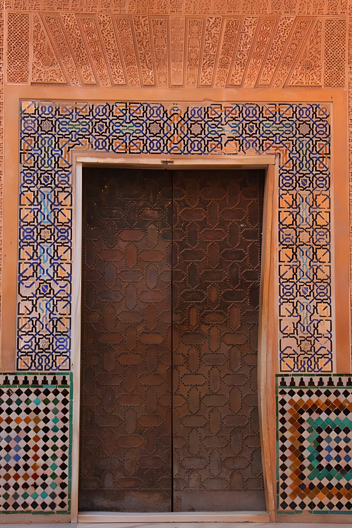Dark double doors, warm mosaic colours