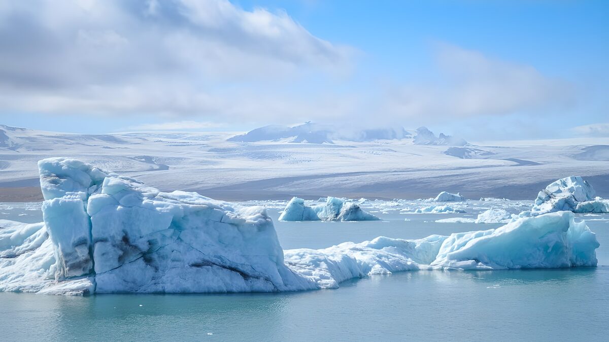 Pale-blue icebergs on still water