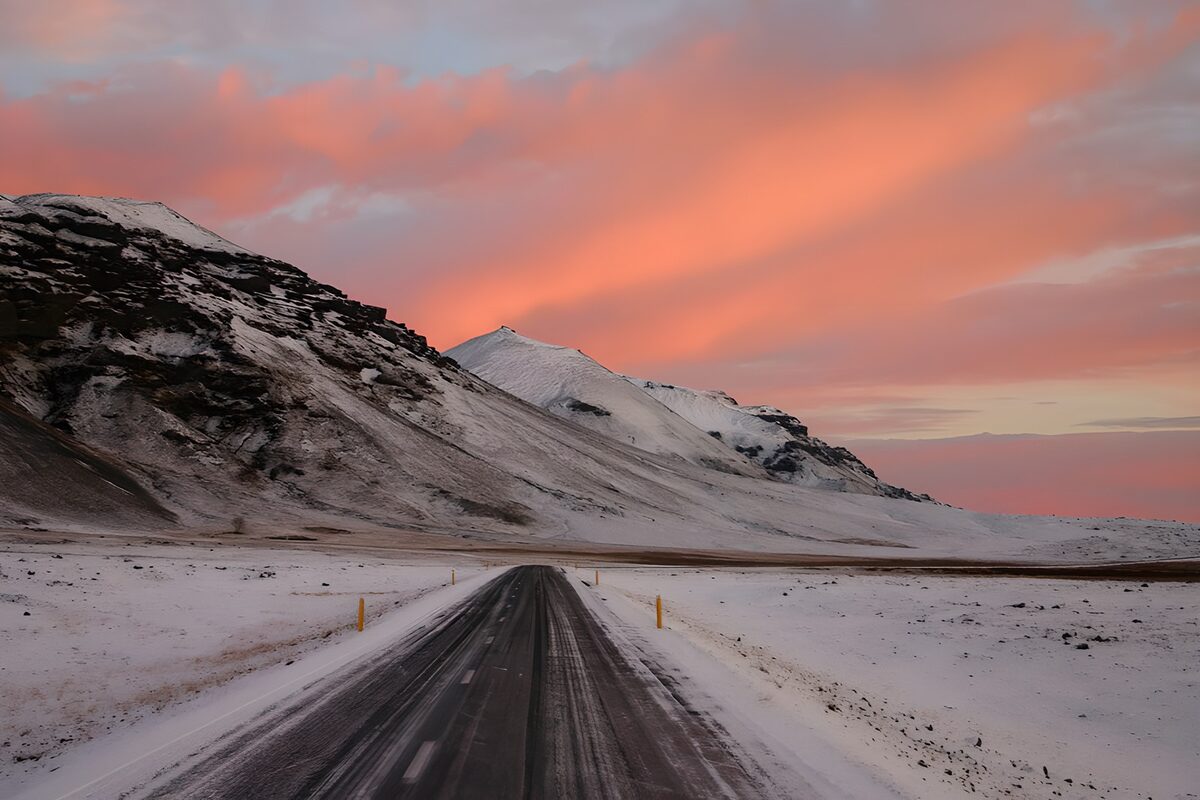 Winter road beneath a pink sky