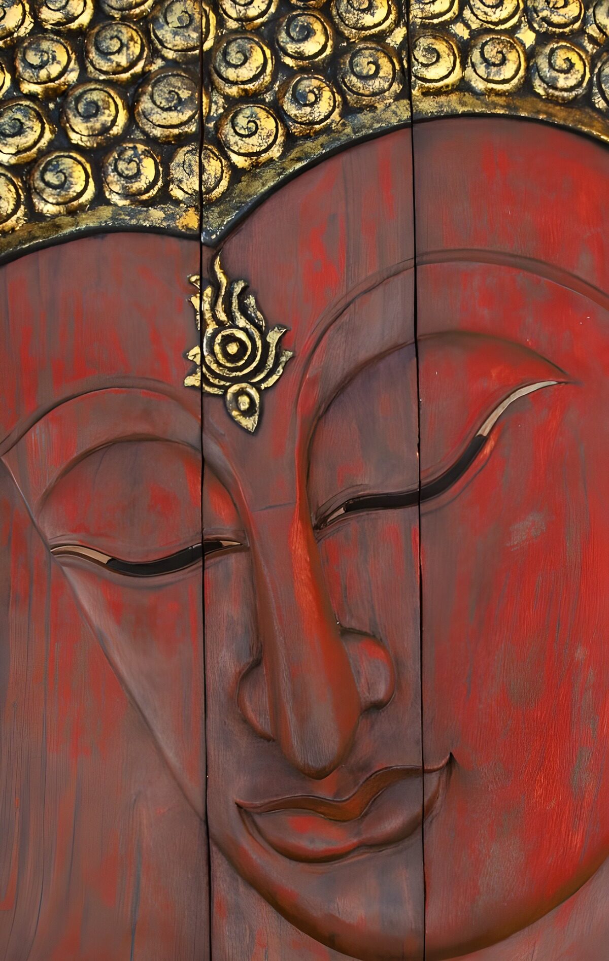 Red wooden Buddha with closed eyes