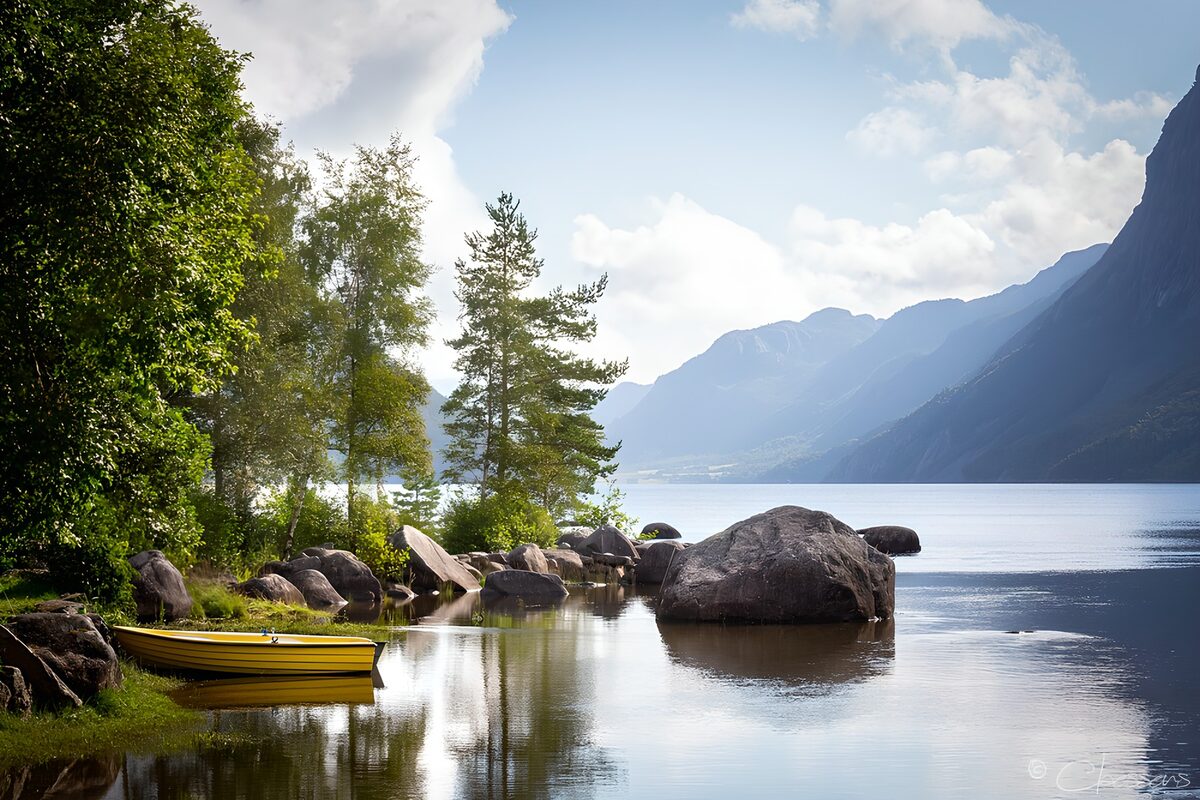 Yellow rowboat on a quiet mountain lake