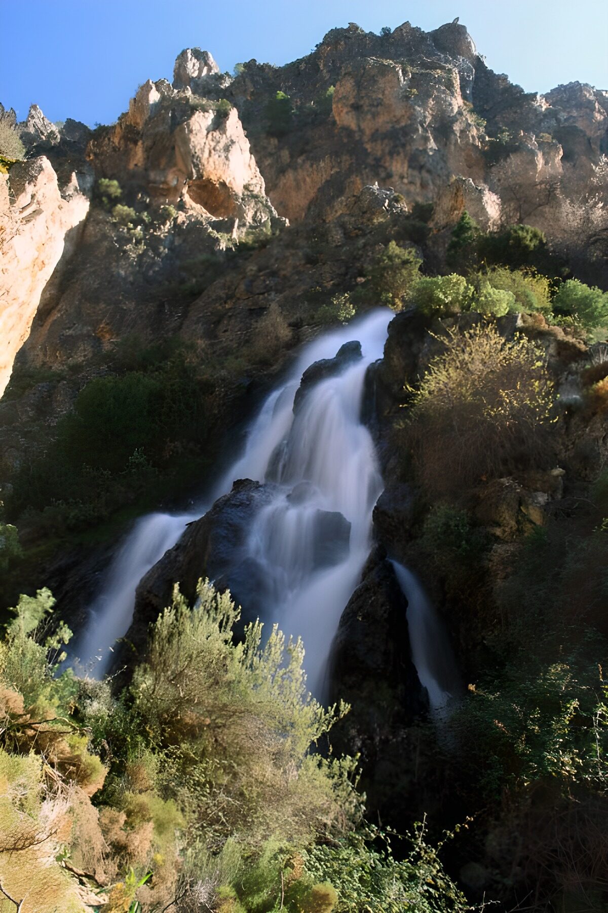 Waterfall in a shadowy rocky gorge