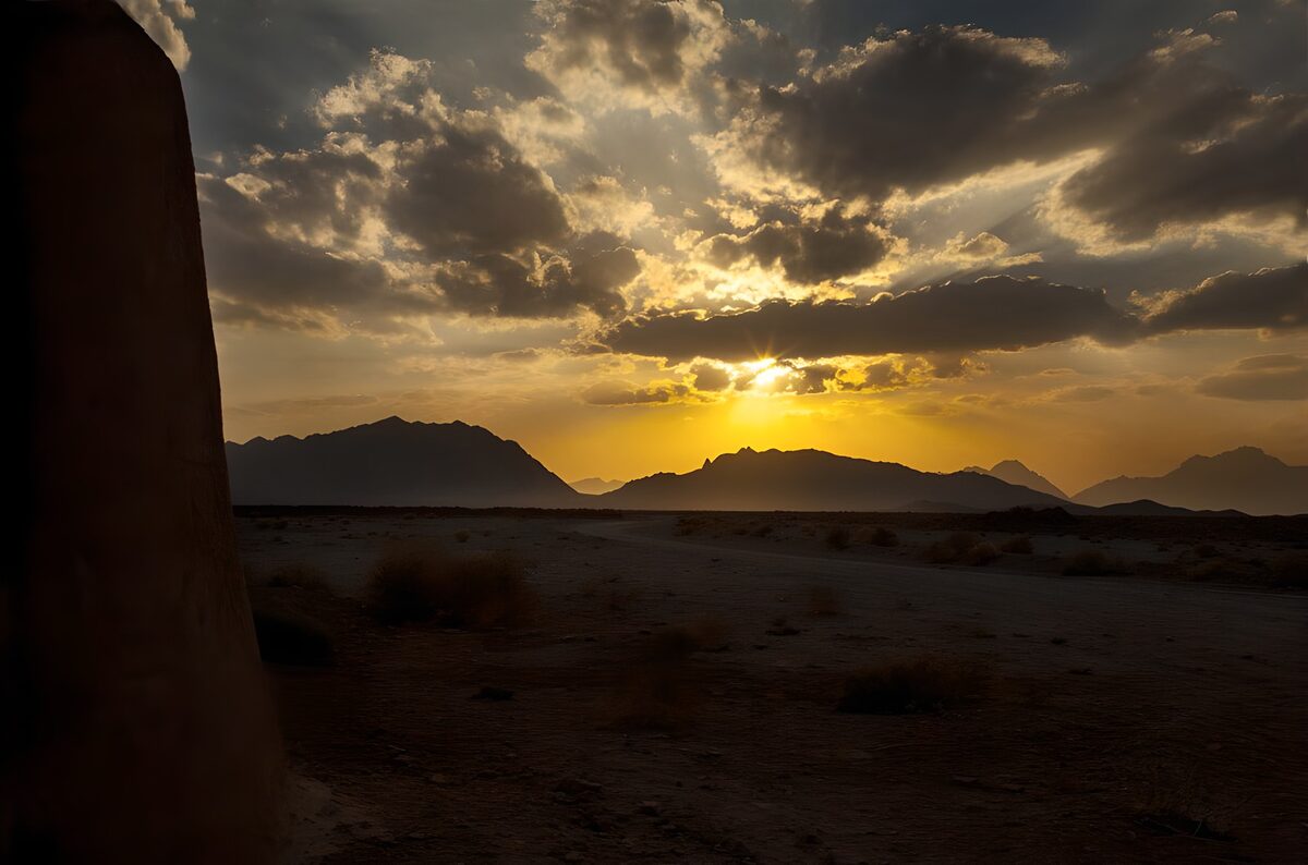 Desert mountains beneath a golden sunset