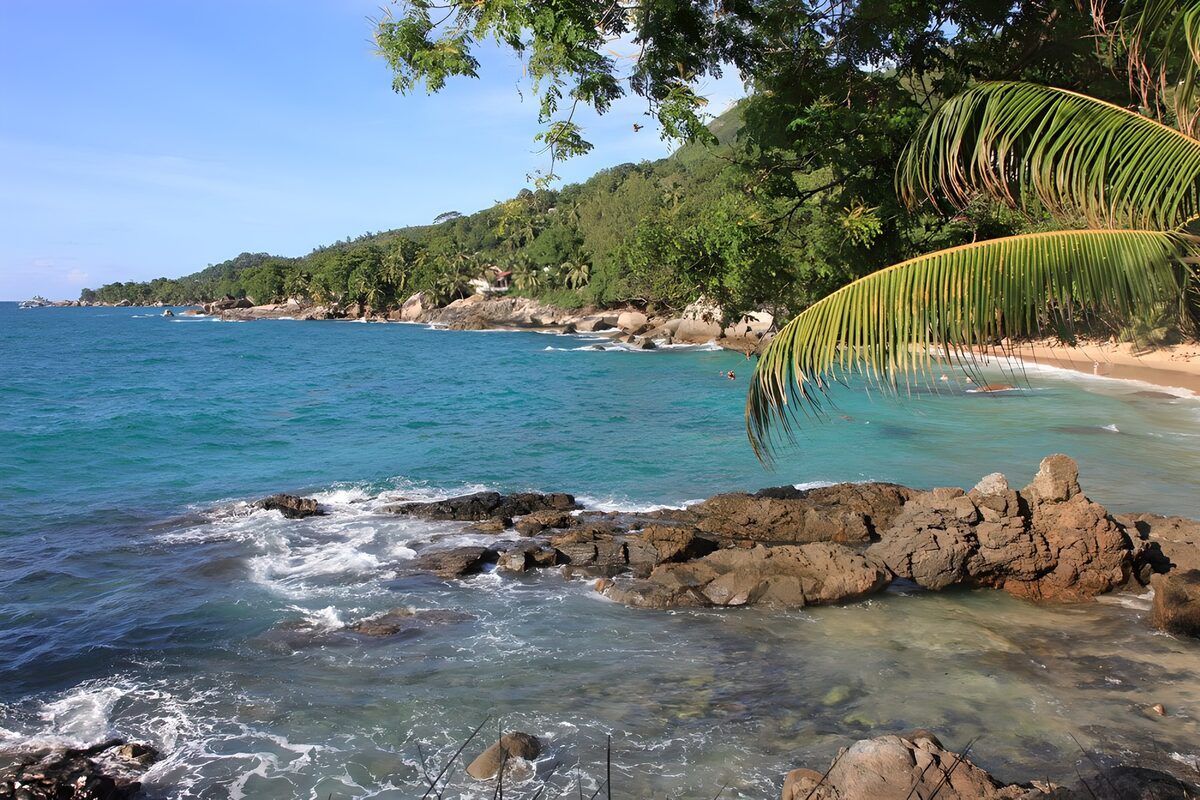 Sunlit tropical bay with rocky shores
