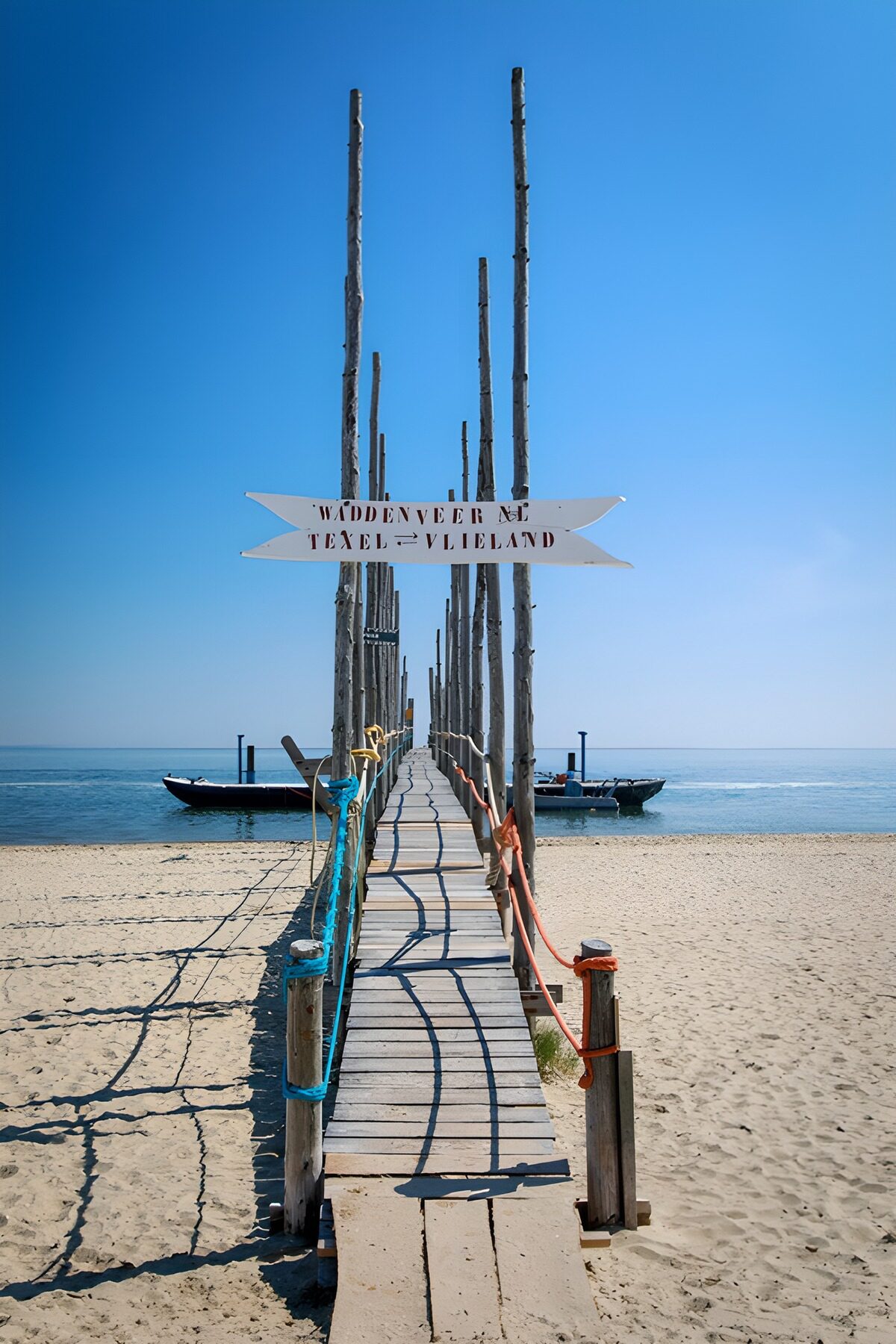 Sunlit wooden jetty across the beach