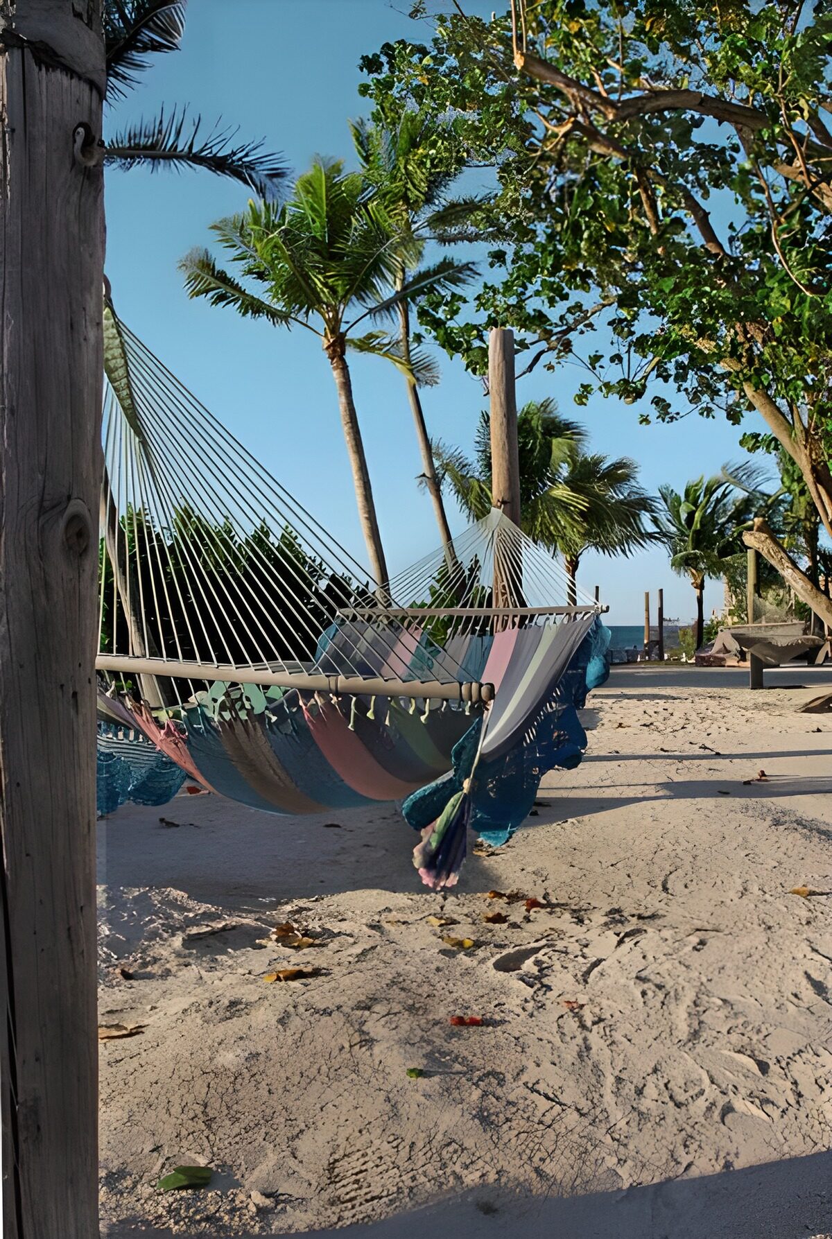 Striped hammocks on a sunlit beach