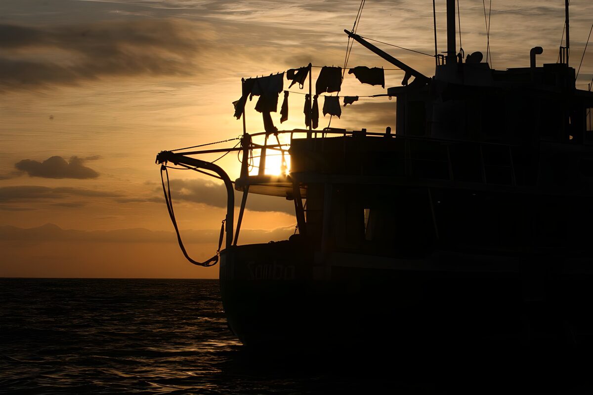 Boat silhouette against a golden sunset