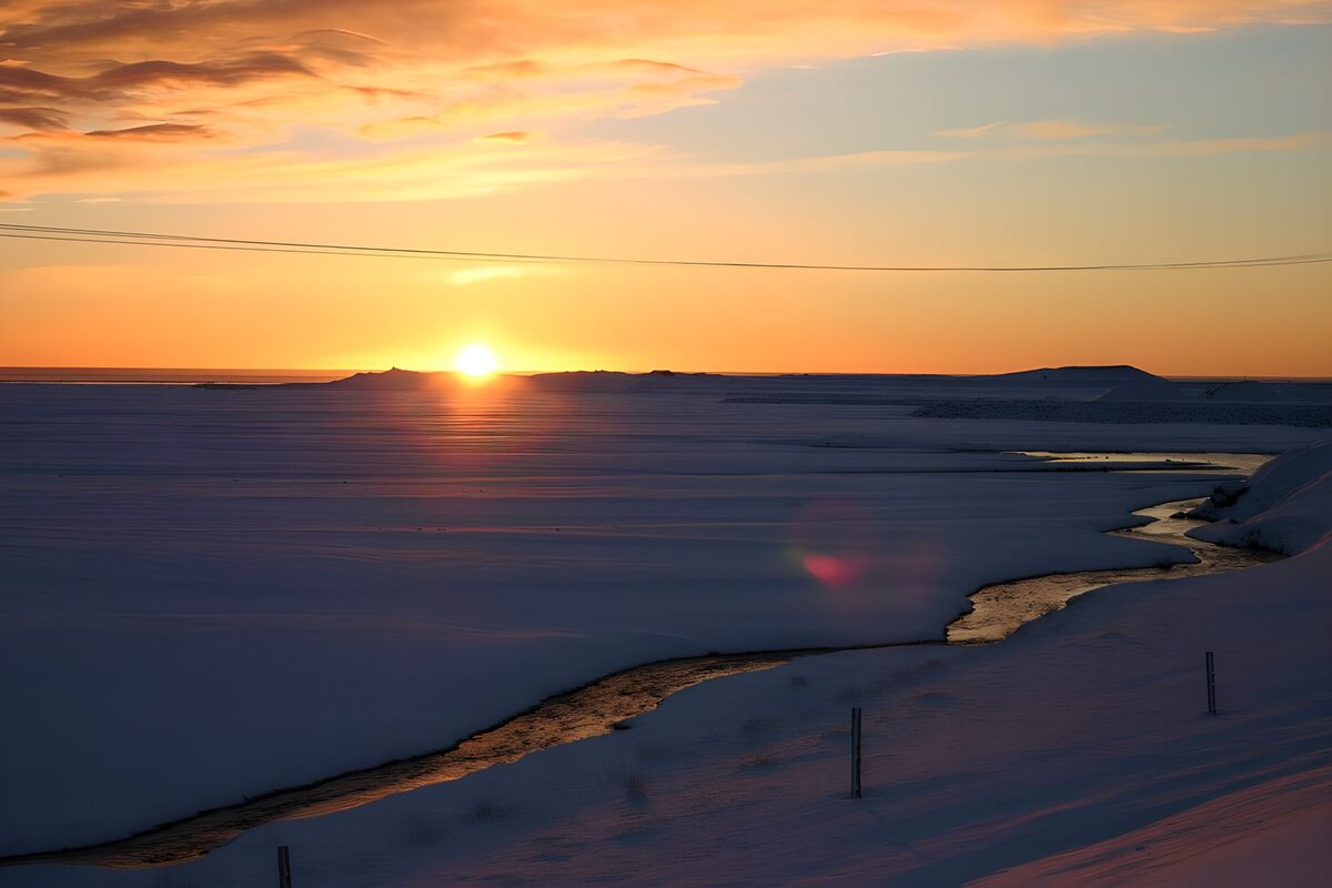 Snow-covered plain at sunset