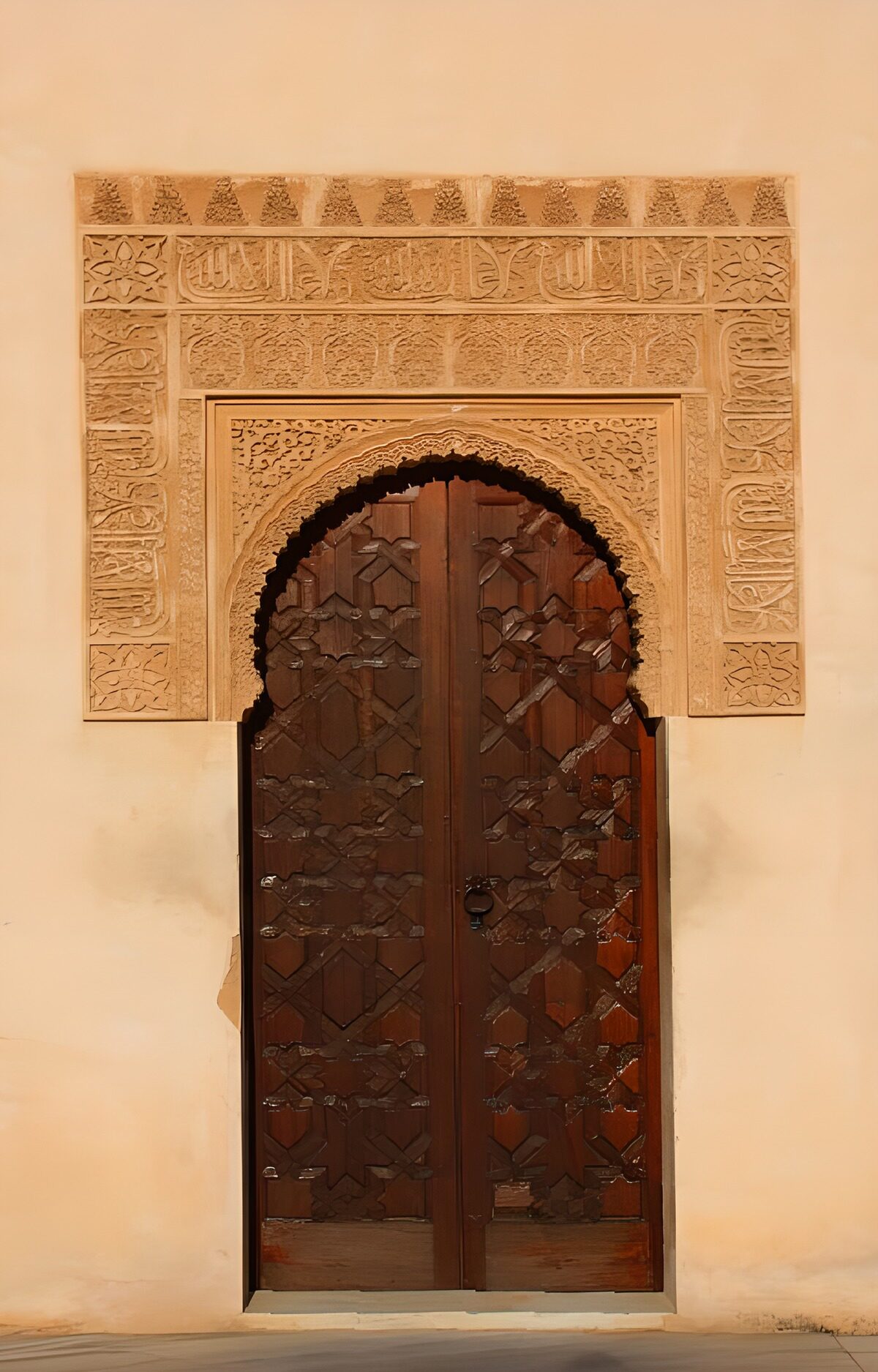 Carved wooden doors in an ornate stone arch