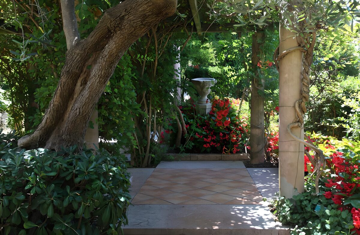 Sun-dappled path between stone columns