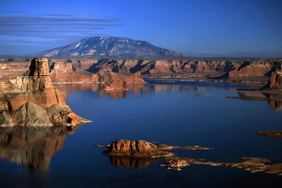 Red cliffs above a deep blue lake
