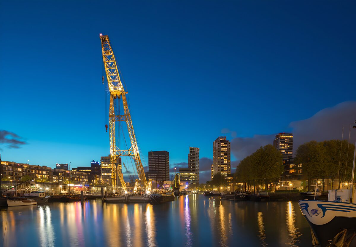 Harbour boats and a crane at twilight